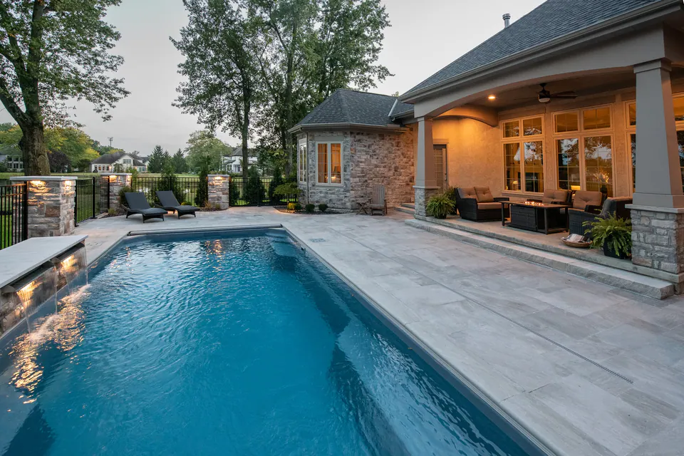 Round fire feature seating area near a poolside terrace